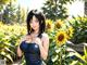 A woman standing in a field of sunflowers.