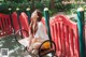 A woman sitting on a bench in a park.