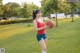 A woman holding a basketball in a field.