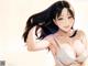 Anime girl with long black hair wearing a white bra.