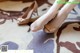 A woman's feet in high heels on a rug.