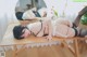 A woman laying on top of a wooden table.